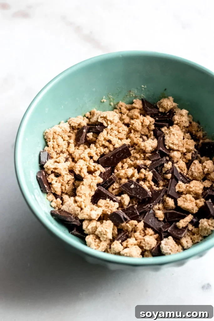 One Bowl Chocolate Chunk Cookies Unbaked cookie dough resting in a mixing bowl, ready to be scooped and chilled.