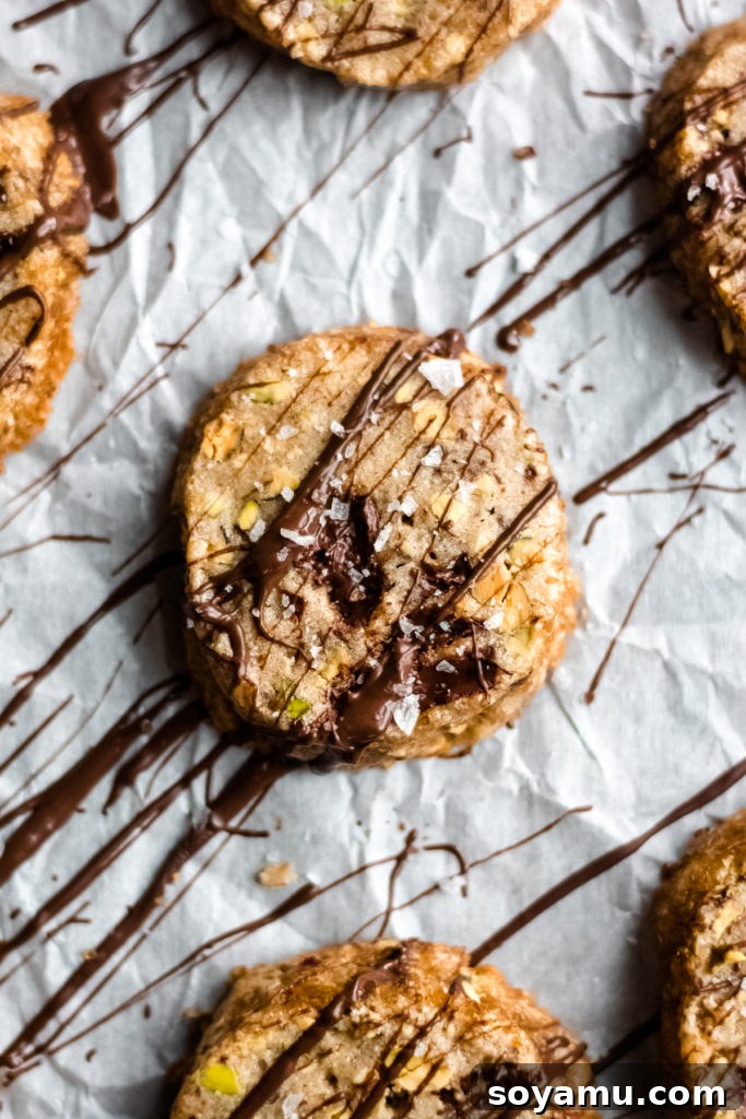 Close-up view of a baked chocolate pistachio cookie revealing its texture.