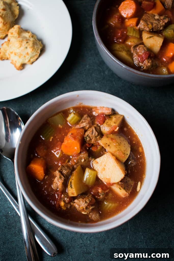 A spread of homemade vegetable beef soup and cheddar biscuits, ready to eat.
