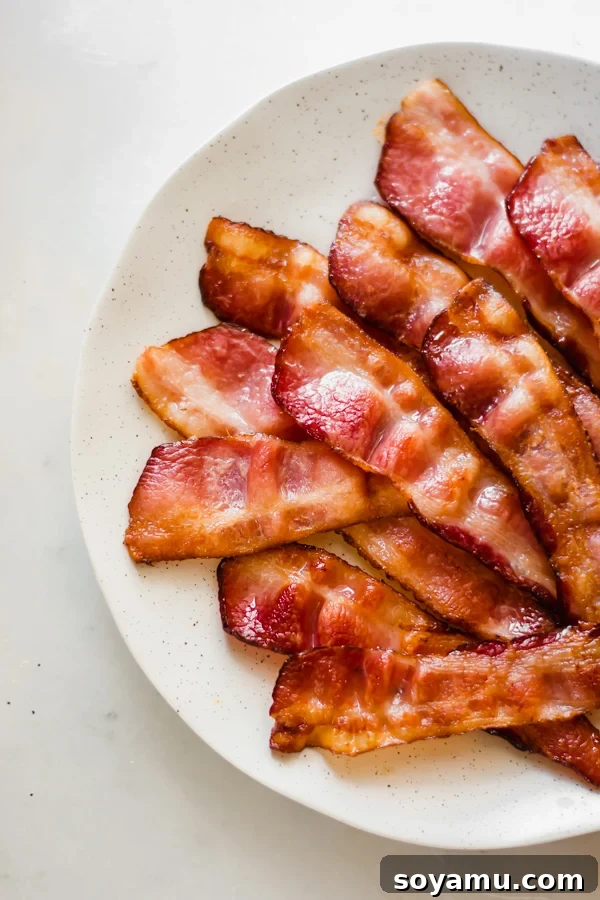 Strawberry Bacon Summer Salad with Poppyseed Perfection 4 Crispy bacon strips on a plate, ready to be crumbled into a salad.