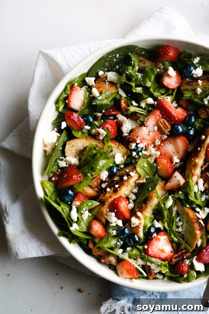 Strawberry Bacon Summer Salad with Poppyseed Perfection 7 Another view of the Strawberry Summer Salad in a bowl, highlighting its fresh ingredients and vibrant colors.