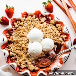 Easy One Bowl Strawberry Rhubarb Crumble 8 Strawberry rhubarb crumble in a pie dish topped with scoops of ice cream.