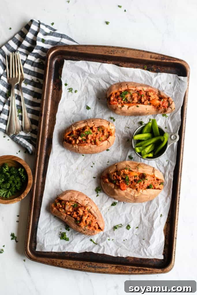 Nourishing Homemade Sloppy Joes 7 Sloppy joes over sweet potatoes on a tray, ready to be served, with a rustic background.