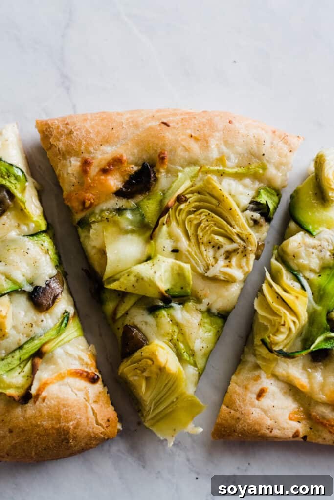 Delicious Green Goddess Pizza Slice Close-up of a perfectly baked slice of green goddess pizza, highlighting the texture of the vegetables and golden crust.