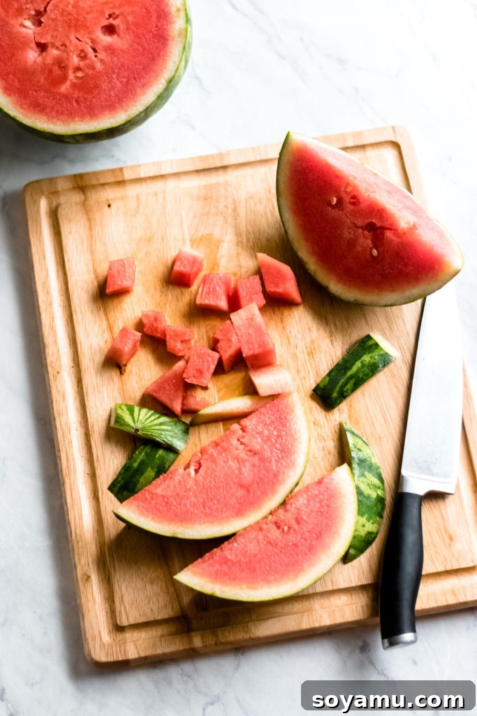 Fresh watermelon on a cutting board, ready to be sliced for the salad.