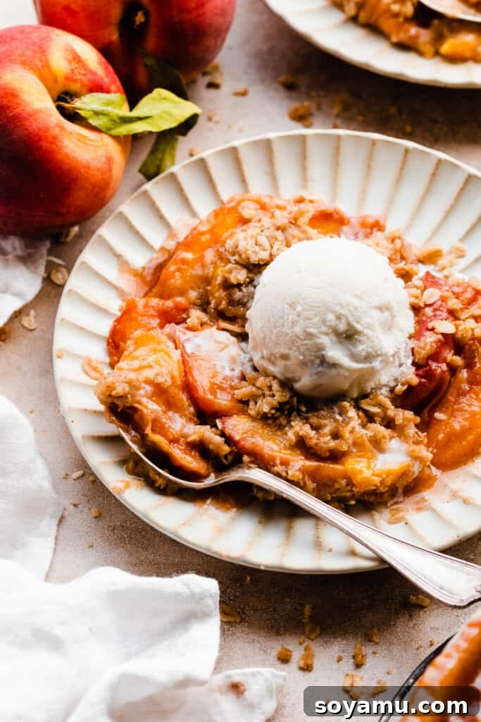 Heavenly Brown Butter Peach Crisp 3 Individual plates of peach crisp, garnished with melting vanilla ice cream, waiting to be enjoyed.