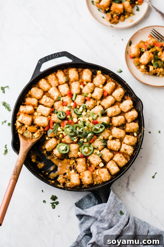 Healthier Tater Tot Hot Dish - Cozy, Flavorful, and Easy Fall Dinner A perfectly baked healthier tater tot hot dish in a rustic skillet, ready to serve.