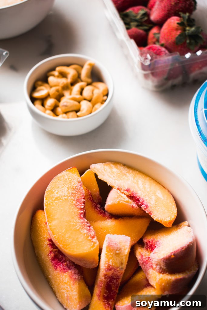 Effortless Vitality: 4 Wholesome Smoothie Creations 3 A selection of frozen fruits like blueberries, strawberries, and banana chunks in clear bags, ready for smoothie preparation.
