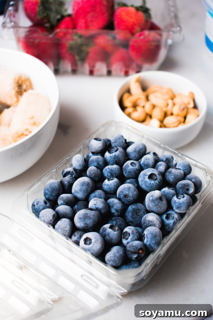 Effortless Vitality: 4 Wholesome Smoothie Creations 4 Close-up of frozen strawberry halves, showcasing their texture and vibrant color, ready for blending.