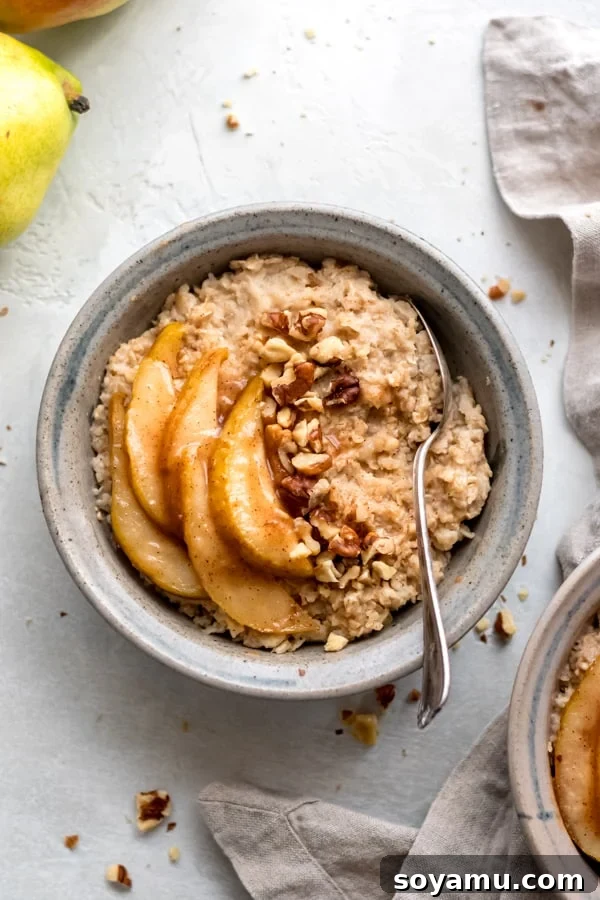 Caramelized Pear Oatmeal Bowls Hearty caramelized pear oatmeal bowls, garnished with fresh pear slices and walnuts, ready for a comforting fall breakfast.