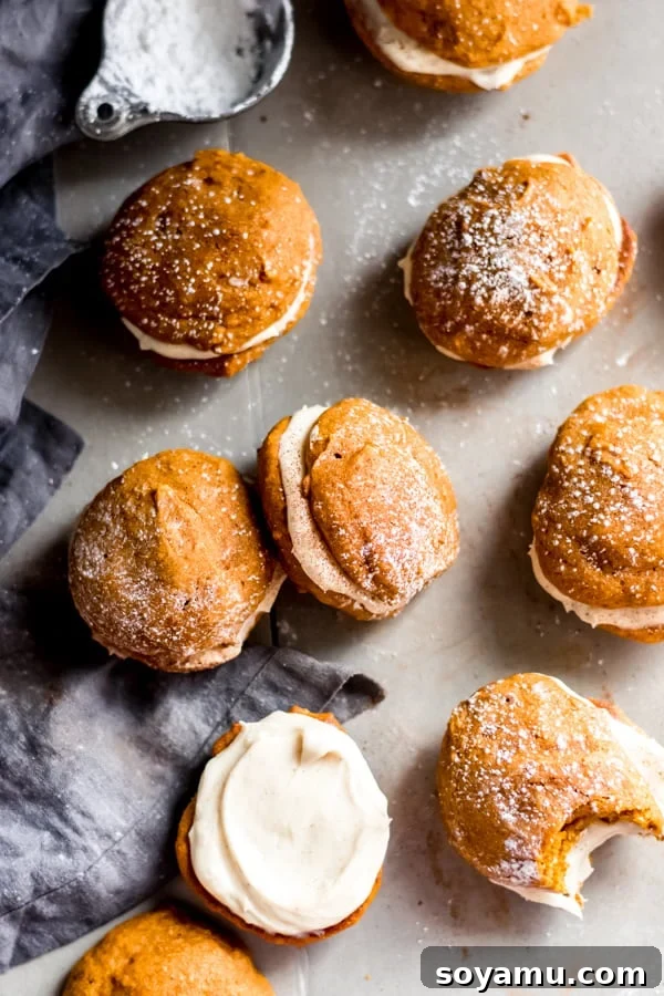 Pumpkin Whoopie Pies with Brown Butter Cream Cheese Frosting Pumpkin whoopie pies with a creamy brown butter cream cheese frosting filling, stacked on a plate ready to be devoured.