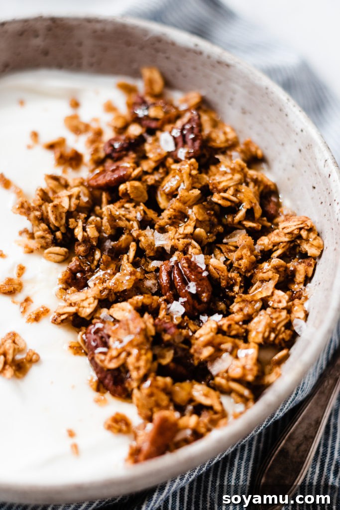 Close-up of baked homemade pumpkin granola spread on a baking sheet, showing crisp clusters.