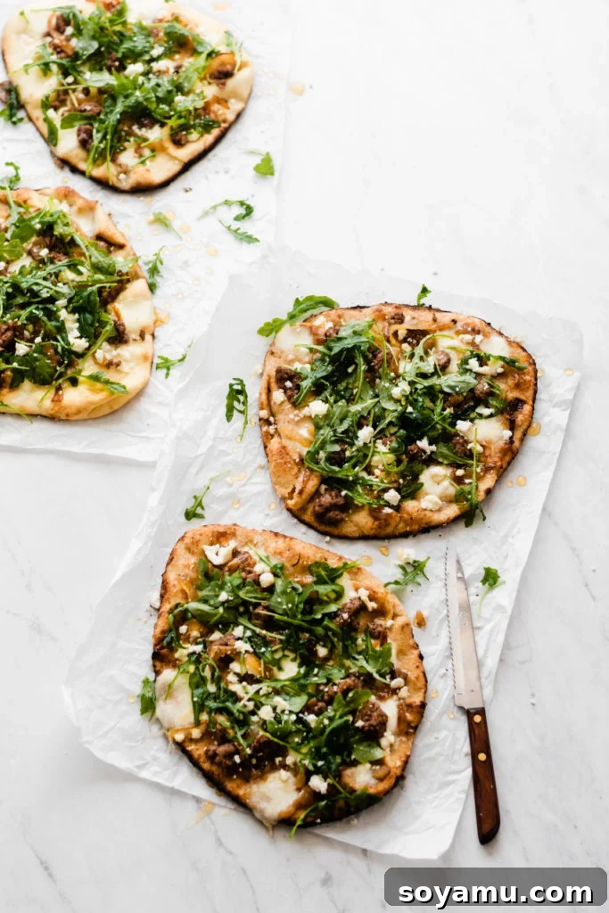 Another view of grilled lamb pizzas topped with fresh arugula and honey, ready to be enjoyed