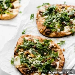 Thumbnail of Grilled Lamb Pizzas with Feta, Arugula, and Honey, showing the delicious toppings