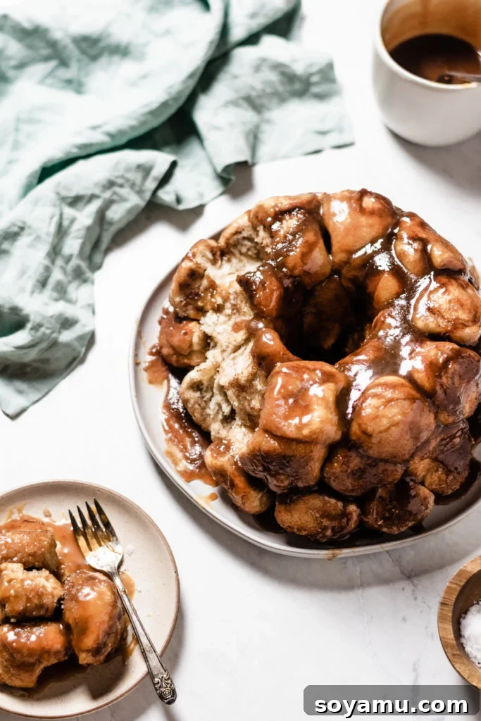 An overhead shot of a full Caramel Apple Cider Monkey Bread, glistening with homemade caramel sauce and cinnamon sugar, ready to be served.