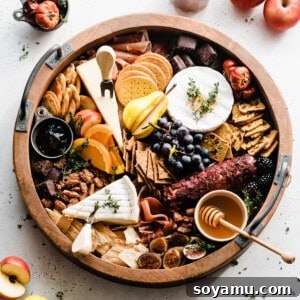 A large round charcuterie board filled with all the bounty of autumn.