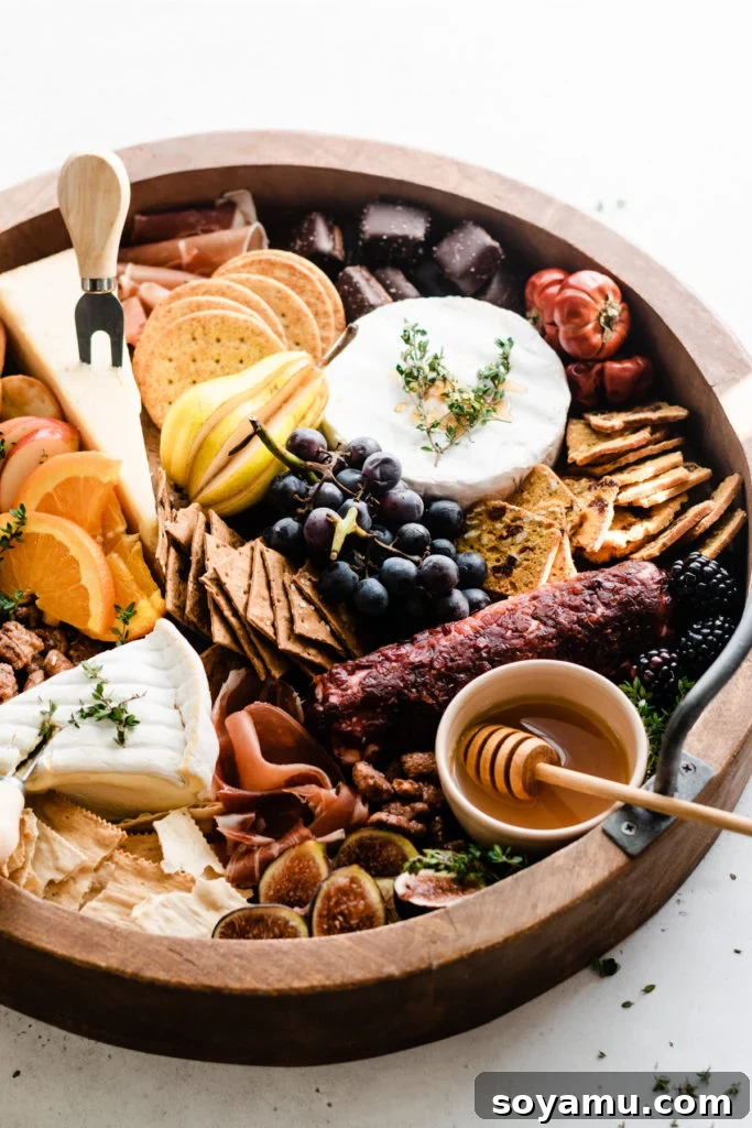 Fall Harvest Cheese Board - The ultimate guide to assembling a spectacular fall-themed charcuterie board. A rustic round wooden board generously laden with autumnal ingredients, including an assortment of cheeses, crispy crackers, various cured meats, juicy grapes, figs, and small bowls of spreads.