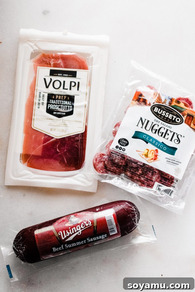 Autumn Bounty Board 3 An assortment of gourmet cured meats, including thinly sliced prosciutto and various salamis, neatly arranged on a light surface, ready to be added to the charcuterie board.