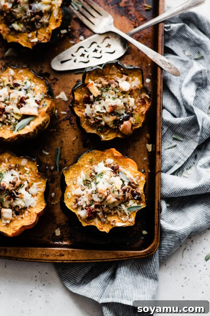 Close-Up of Culinary Perfection: Golden Stuffed Acorn Squash with Melted Parmesan. A close-up shot of the pan, showcasing the beautifully golden and richly filled acorn squash halves, with melted Parmesan cheese glistening on top.