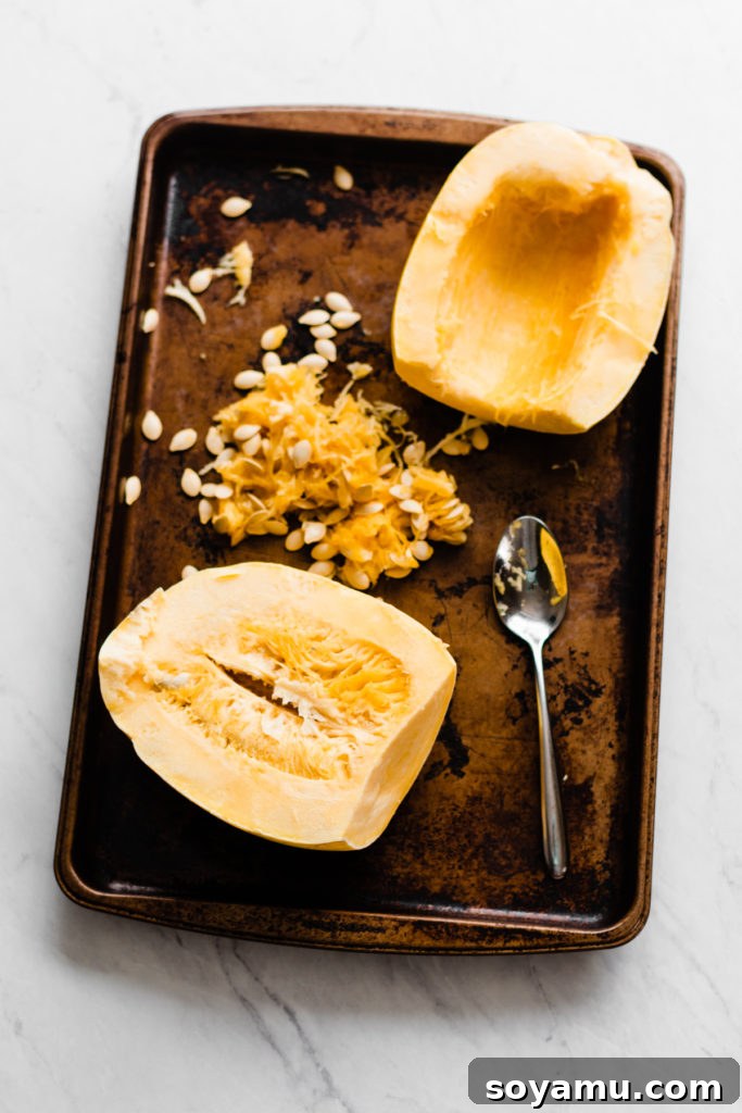 Preparing Spaghetti Squash: Halving and Seeding Spaghetti squash halved and seeded, ready for seasoning.