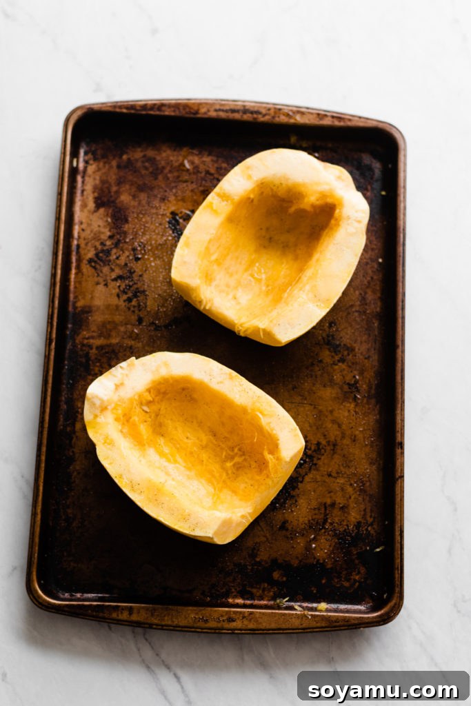Seasoning Spaghetti Squash for Roasting Spaghetti squash halves seasoned with olive oil, salt, and pepper.