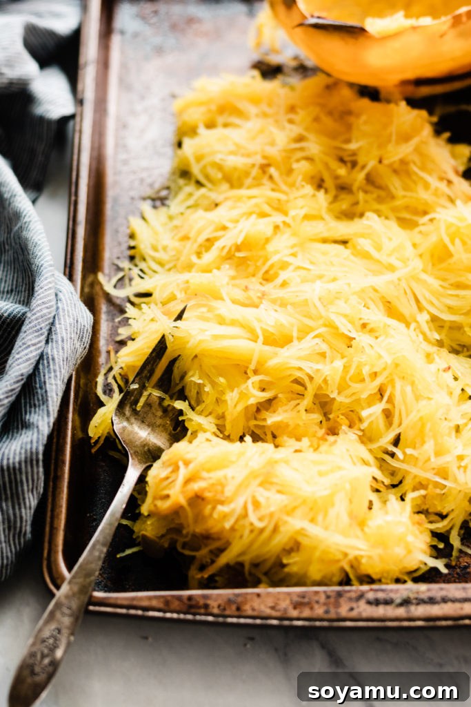 Freshly Shredded Spaghetti Squash Strands A bowl filled with freshly scraped spaghetti squash strands, ready for use.