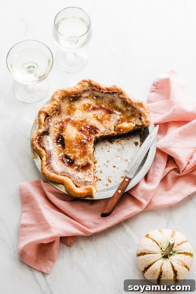 A decadent Brûléed Maple Pie, perfect for holiday gatherings Rich Brûléed Maple Pie with a golden caramelized sugar topping, ready for Thanksgiving