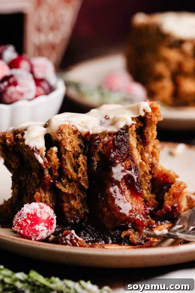 A close-up shot revealing the tender, spiral layers and gooey, spiced molasses filling of a gingerbread cinnamon roll.