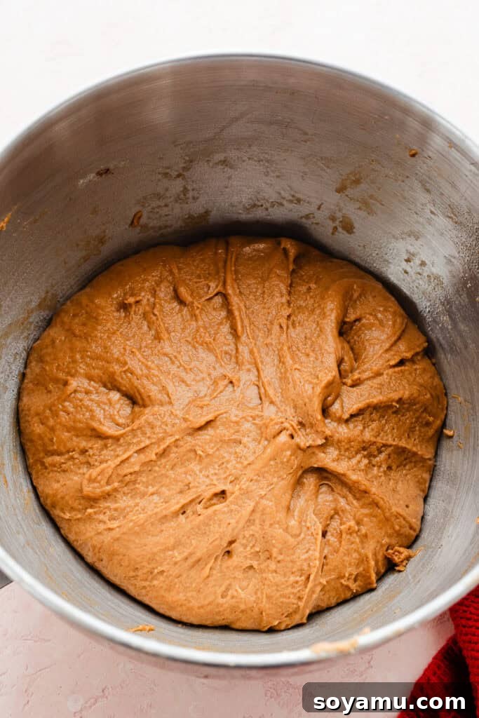 A bowl of freshly kneaded gingerbread dough, before its first rise, smooth and ready to proof.