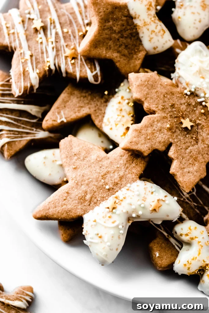 Detail of a Spiced Maple Cutout Cookie with Gold Stars A close-up of a single Cinnamon Spiced Maple Cutout Cookie with white chocolate and gold star sprinkles, emphasizing its soft texture.