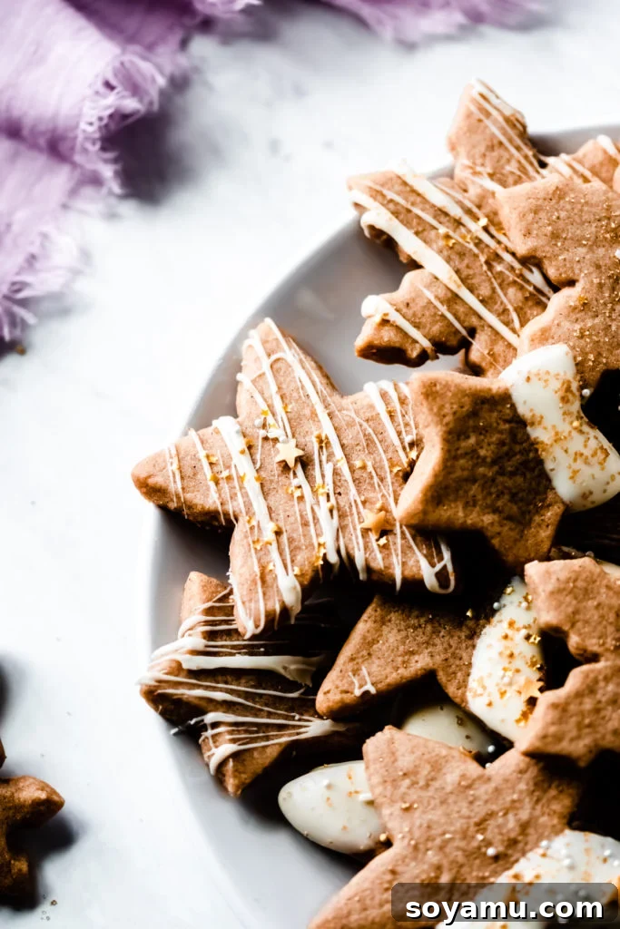 Perfectly Baked Maple & Cinnamon Cutout Cookies for Any Occasion A close-up of beautifully baked Cinnamon Spiced Maple Cutout Cookies arranged on a cooling rack, ready for festive decoration.