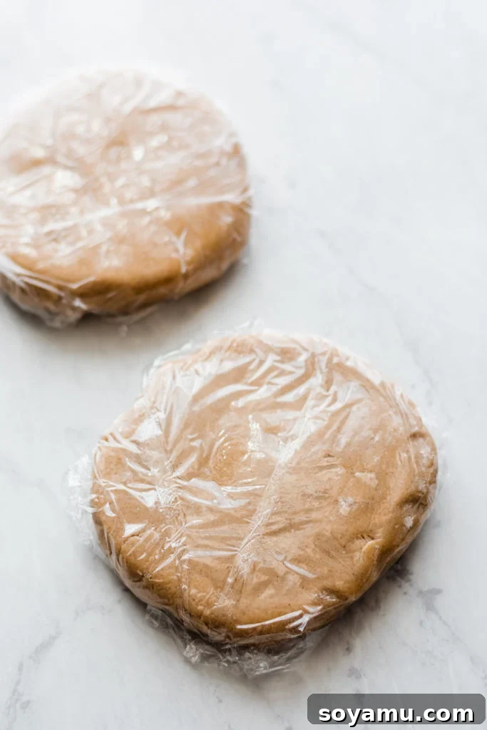 Freshly Baked Cinnamon Maple Cutout Cookies Cooling A batch of baked Cinnamon Spiced Maple Cutout Cookies cooling on a wire rack, perfectly shaped and golden brown, awaiting decoration.