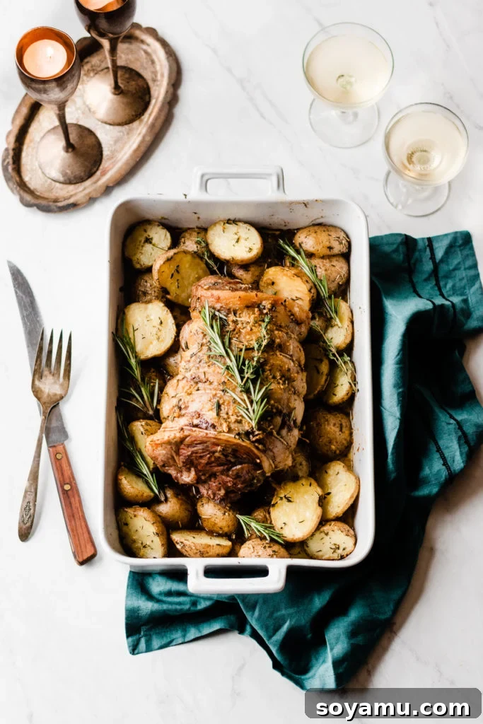 Herbed Garlic Butter Lamb Roast with Roasted Potatoes - A show-stopping, yet simple, lamb roast recipe perfect for holidays and family dinners. Herbed Garlic Butter Lamb Roast with Roasted Potatoes - The ultimate holiday dinner recipe that's both stunning and incredibly easy to make. Featuring tender lamb marinated in olive oil and herbs, paired with crispy potatoes coated in melted butter, garlic, and fresh herbs, all roasted together for an explosion of flavor. Perfect for Christmas dinner, special occasions, or an impressive family meal. #LambRoast #HolidayDinner #GarlicButterPotatoes #EasyRecipes #ChristmasRecipes #GlutenFree #HealthyRecipes #FamilyMeal #RoastDinner