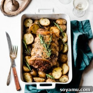 Lamb Roast with Herbed Garlic Butter Potatoes - The holiday dinner that tastes + looks fabulous, while secretly being extremely simple to make! Rub the lamb with olive oil + herbs and drench the potatoes in melted butter, garlic, and herbs and roast everything for the most flavorful dinner! #dinnerrecipes #holidayrecipes #christmasdinner #christmasrecipes #lamb #roast #glutenfreerecipes #easyrecipes #healthyrecipes #bluebowlrecipes | bluebowlrecipes.com