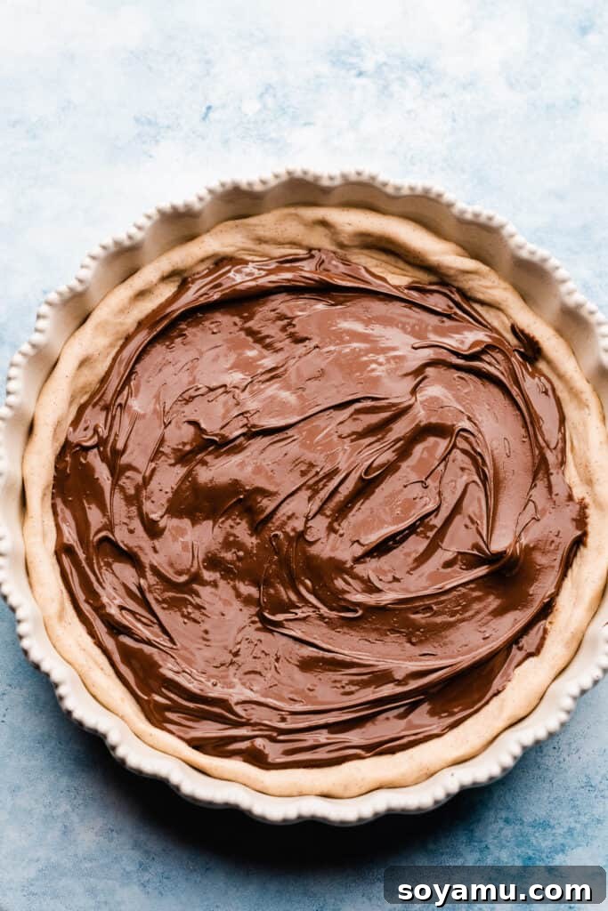 Nutella spread on a pizza crust.