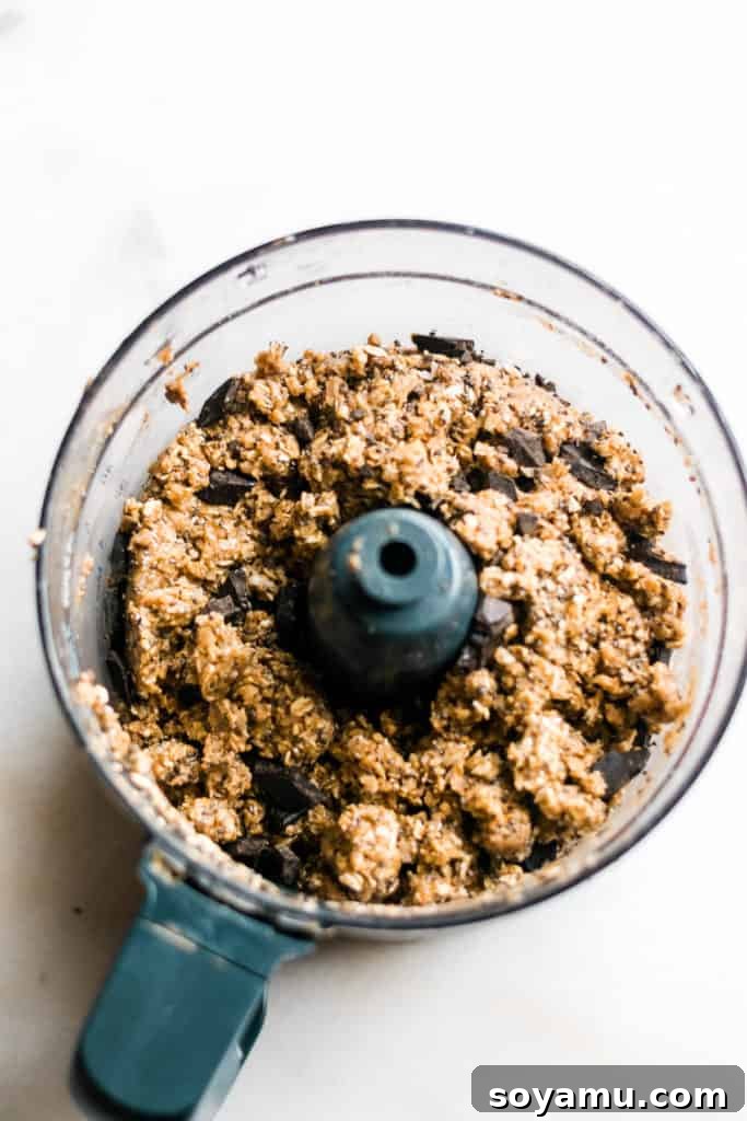 Blended Ingredients for No-Bake Energy Balls Mixing all healthy cookie dough energy bite ingredients in a food processor.