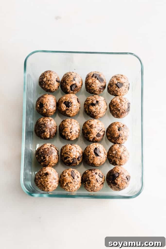 Rolling Healthy Energy Bites Hand rolling the energy bite mixture into small, perfect balls.
