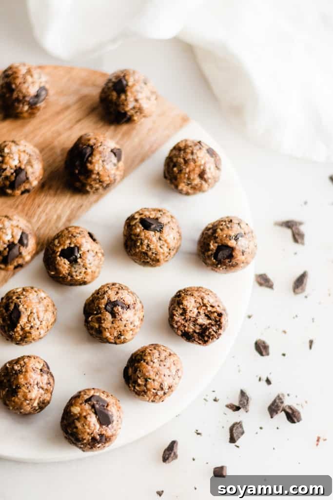 Batch of No-Bake Energy Balls A large batch of healthy cookie dough energy bites on a baking sheet.
