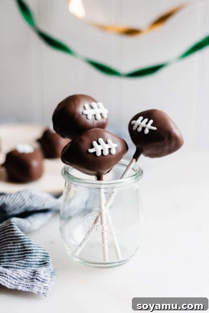 The ultimate fudgy and moist homemade chocolate cake pops, perfect for any celebration! Homemade Chocolate Cake Pops - These rich chocolate cake pops are perfectly fudgy and moist, and are surprisingly easy to make at home! Made with a mix of rich, fudgy chocolate cake, sweetened condensed milk, and silky chocolate frosting - roll this mixture into balls, dip into chocolate, and dig in! #cakepops #chocolate #chocolaterecipes #dessertrecipes #valentinesday #superbowl #superbowlfood #birthdayrecipes #birthdaycake #bluebowlrecipes | bluebowlrecipes.com