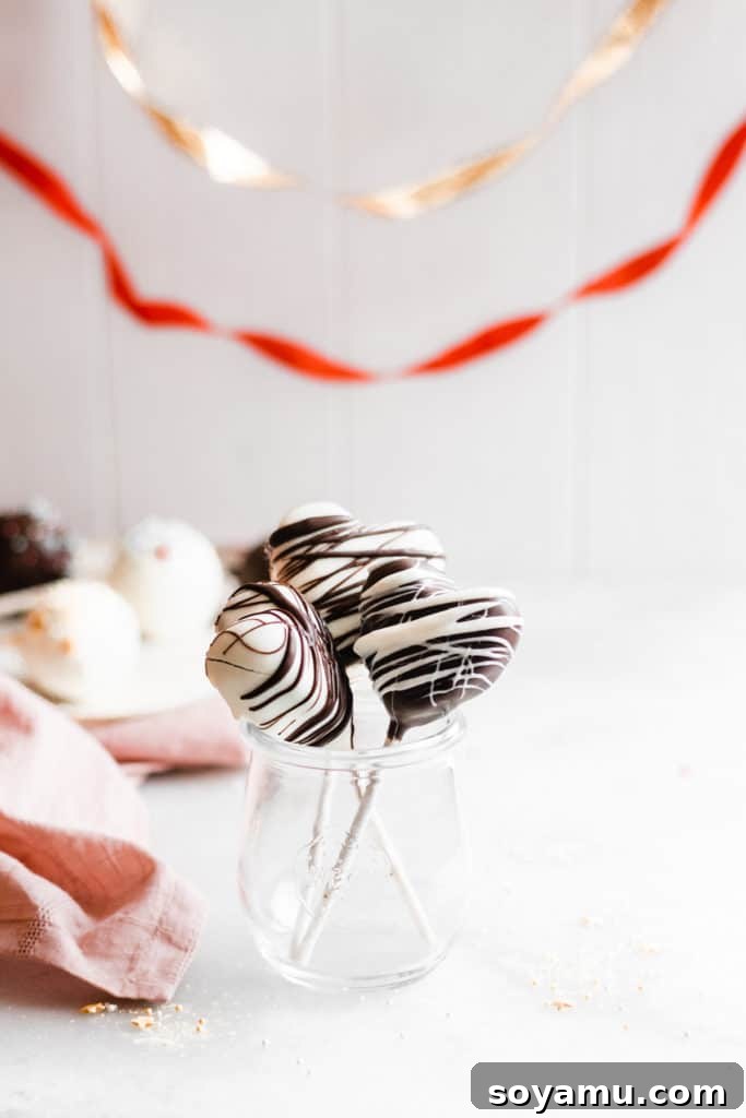 Perfectly dipped chocolate cake pops for game day festivities Delicious chocolate cake pops on sticks, ready for a Super Bowl party or Valentine's Day.