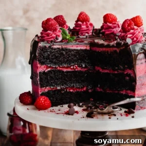 Decadent Raspberry Chocolate Delight 15 Sliced open chocolate raspberry cake on a cake stand.