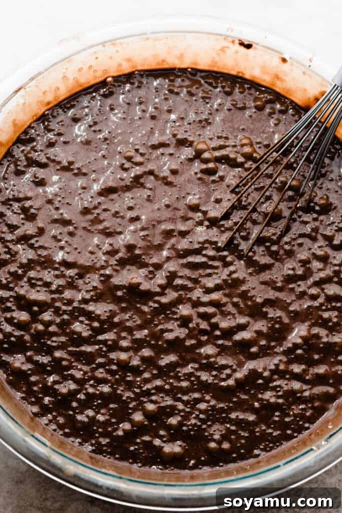 Decadent Raspberry Chocolate Delight 4 A bowl of rich, dark chocolate cake batter, ready for baking.