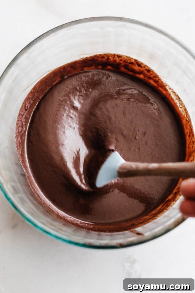 Bailey's Chocolate Mousse Parfaits - Silky smooth layers of Irish cream-infused whipped cream, chocolate whipped cream, and crushed oreos make up these delightful personal-sized desserts! These desserts are so easy to make and are no-bake! Perfect for St. Patrick's Day or any other celebration. Finely chopped semi-sweet chocolate in a bowl, ready for melting