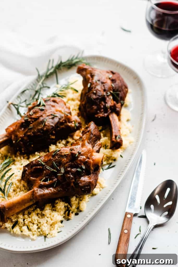 Delicious lamb shanks, perfect for any meal Plated Red Wine Braised Lamb Shanks with couscous and fresh rosemary garnish