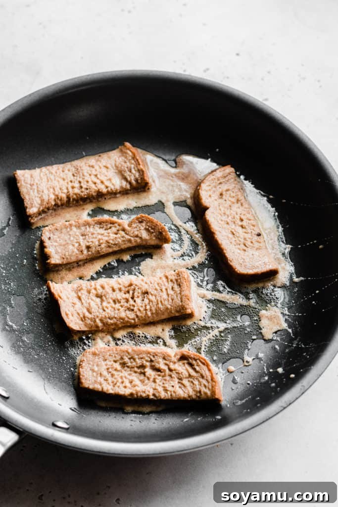 Churro French Toast sticks cooking to golden perfection in a skillet French toast sticks frying in pan