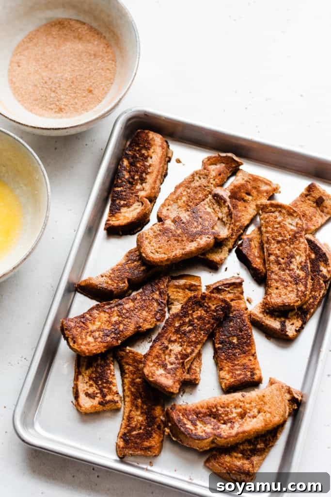 Warm French Toast Sticks prepared for their cinnamon sugar coating French toast sticks ready for cinnamon coating