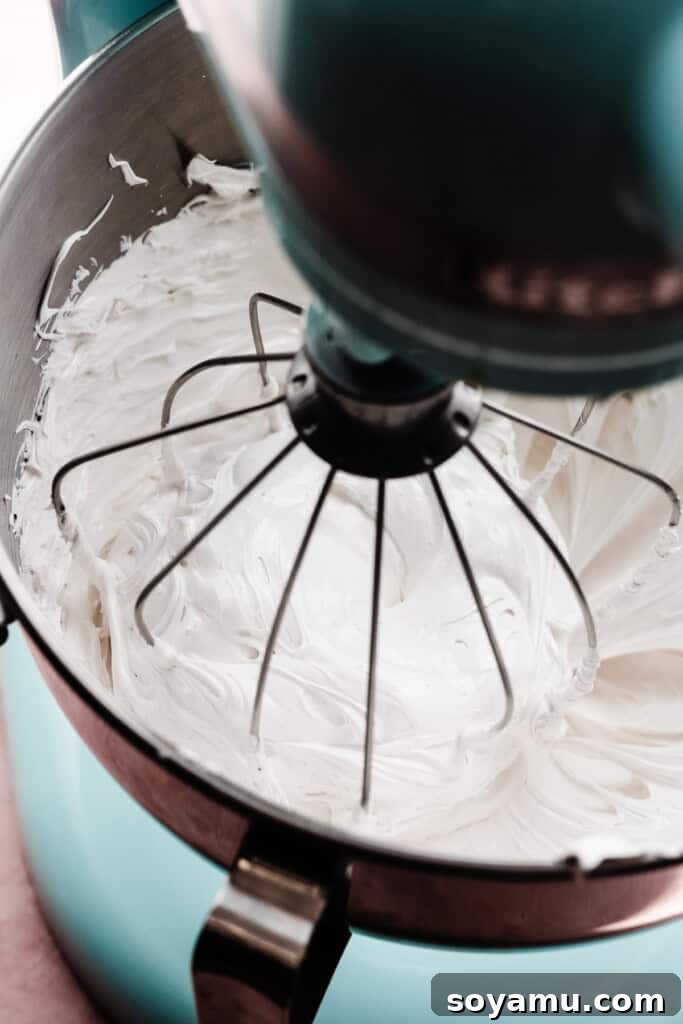 Decadent S'mores Cheesecakes with Golden Marshmallow Meringue 12 A stand mixer full of fluffy marshmallow meringue.