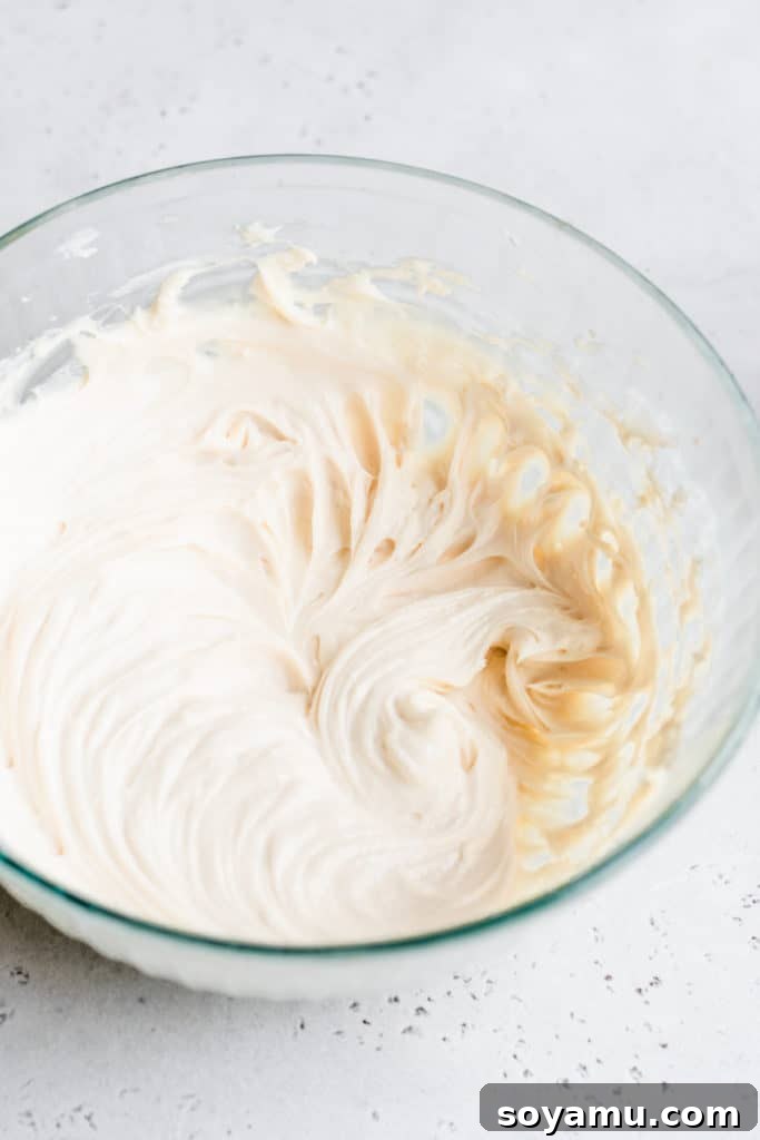 Finished Cheesecake Dip - A bowl of smooth, thick, and creamy no-bake dessert, perfectly blended and ready for presentation. A mixing bowl filled with the freshly prepared, smooth, and incredibly creamy cheesecake dip, showcasing its delightful texture and readiness for serving.