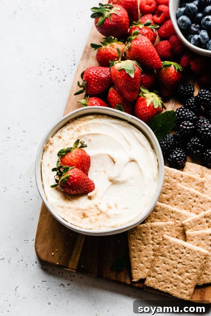 Garnished Cheesecake Dip - A beautifully presented bowl, topped with graham cracker crumbs for a classic cheesecake aesthetic, ready for immediate enjoyment. A close-up view of a pristine serving bowl filled with creamy cheesecake dip, elegantly garnished with a delicate sprinkle of graham cracker crumbs on top, ready for guests to enjoy.