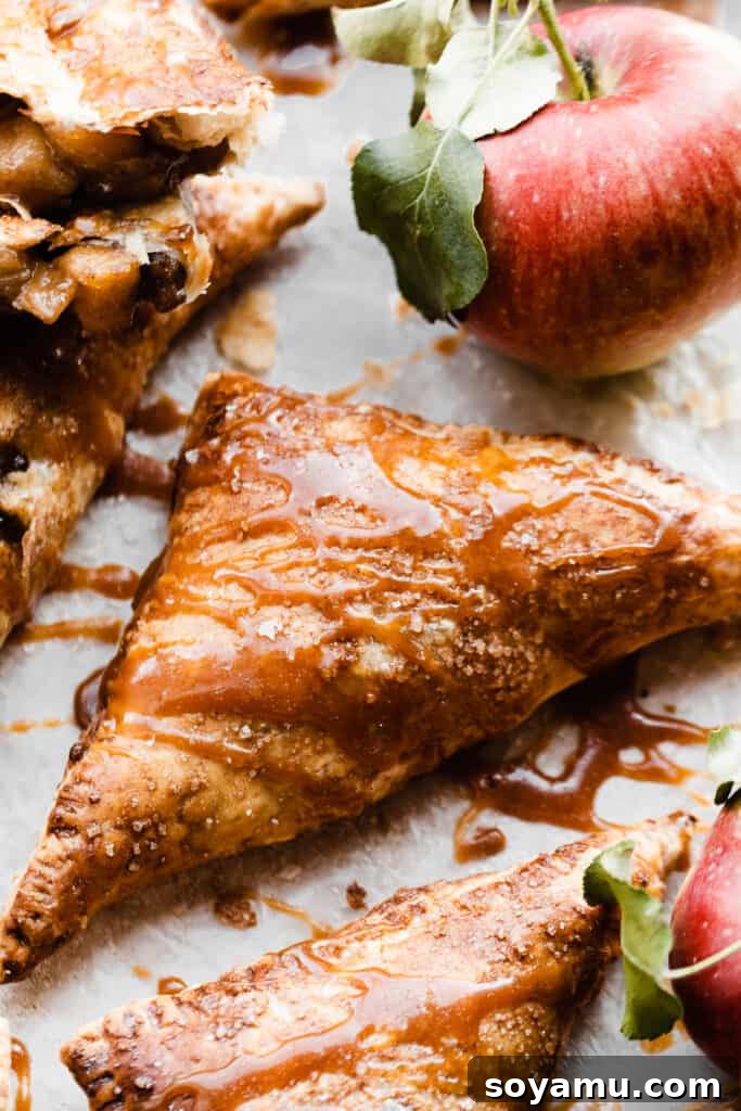 Flaky Caramel Apple Pockets 8 A close-up on a whole turnover, drizzled with salted caramel sauce.